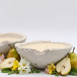 Ceramic bowl with pears and flowers on a white background
