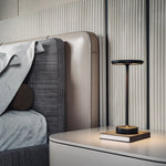 Black cordless table lamp on a bedside table