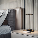 Black cordless table lamp on a bedside table