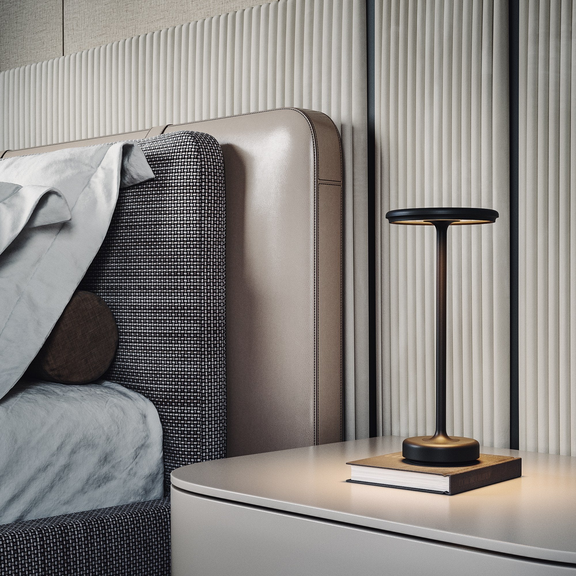 Black cordless table lamp on a bedside table