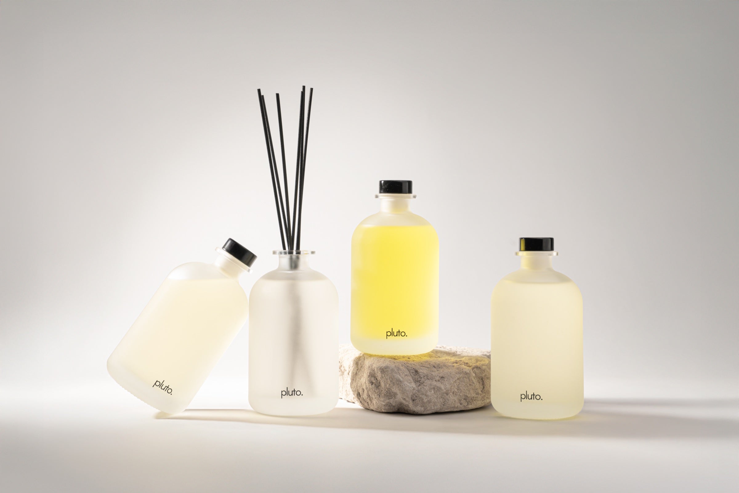 pluto. diffuser quartet on stone, frosted glass bottles, hand-poured Dubai