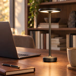 Black cordless lamp on a walnut work desk
