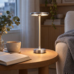 Silver cordless lamp beside a reading armchair