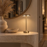 Gold cordless lamp on a travertine hallway console