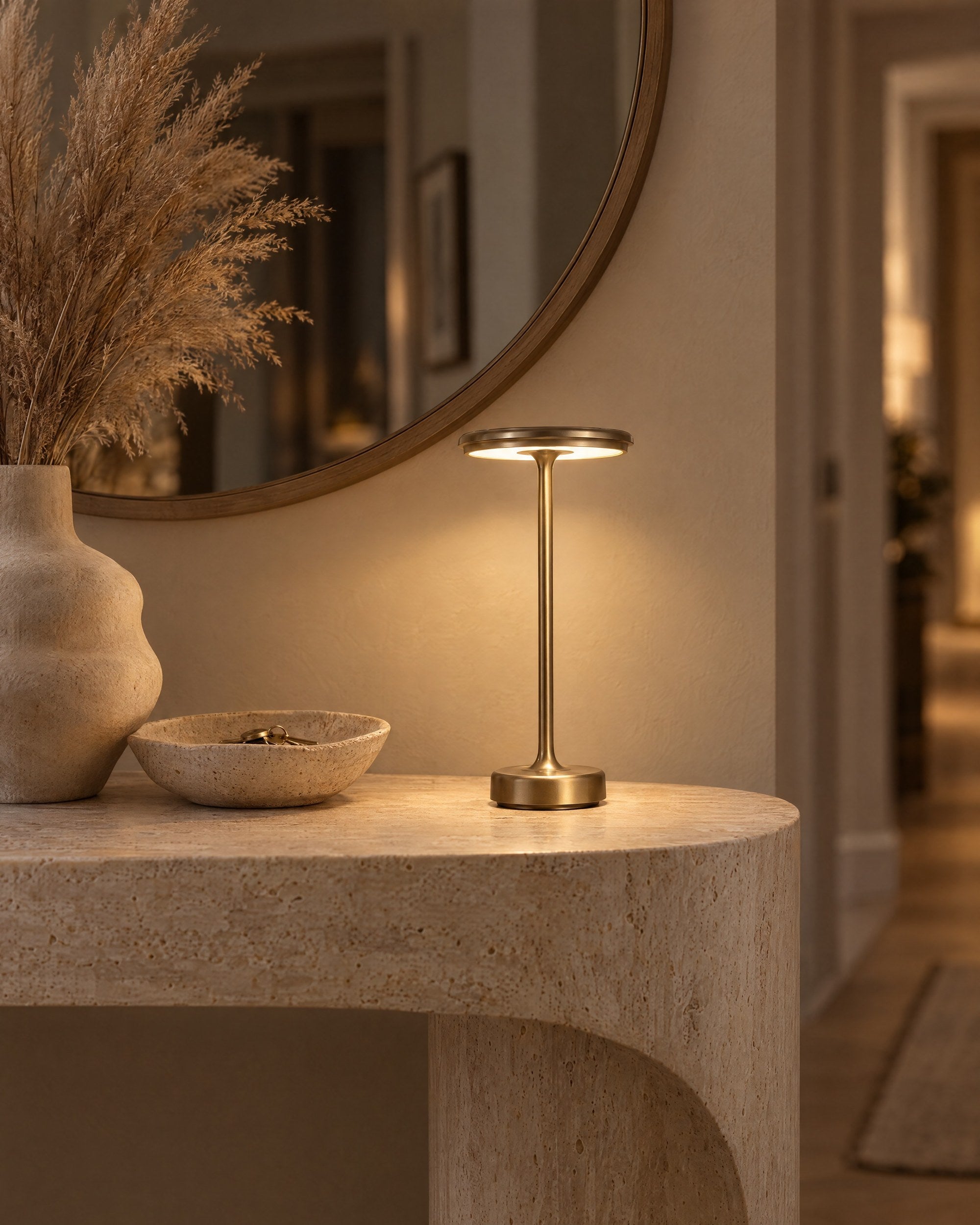 Gold cordless lamp on a travertine hallway console