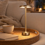 Gold cordless lamp on a rattan tray, portable and cable free