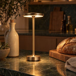Gold cordless lamp on a green marble kitchen counter
